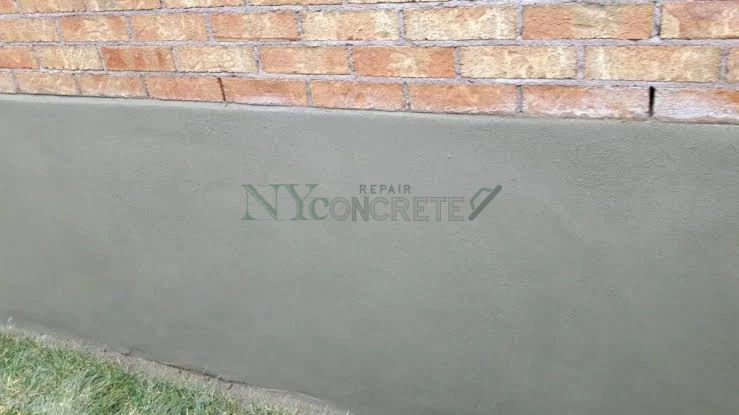 cement based parging coating applied to a masonry foundation wall